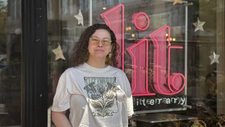a person stands in front of a sign that says "lit"