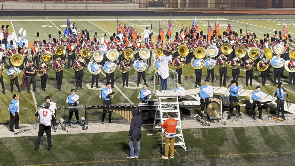 marching band members on a football field