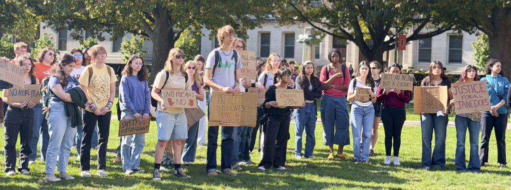 a crowd of people gather with signs outside. some signs read "No Means No," "Justice For All Jane Does," "Safety Is A Human Right"